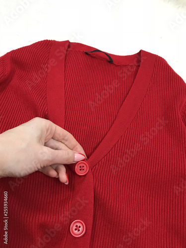 Female red cardigan close up on wooden background
