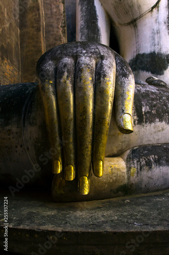 The hand of the big stucco Buddha at Wat Si Chum temple in Sukhothai historical park in Thailand.