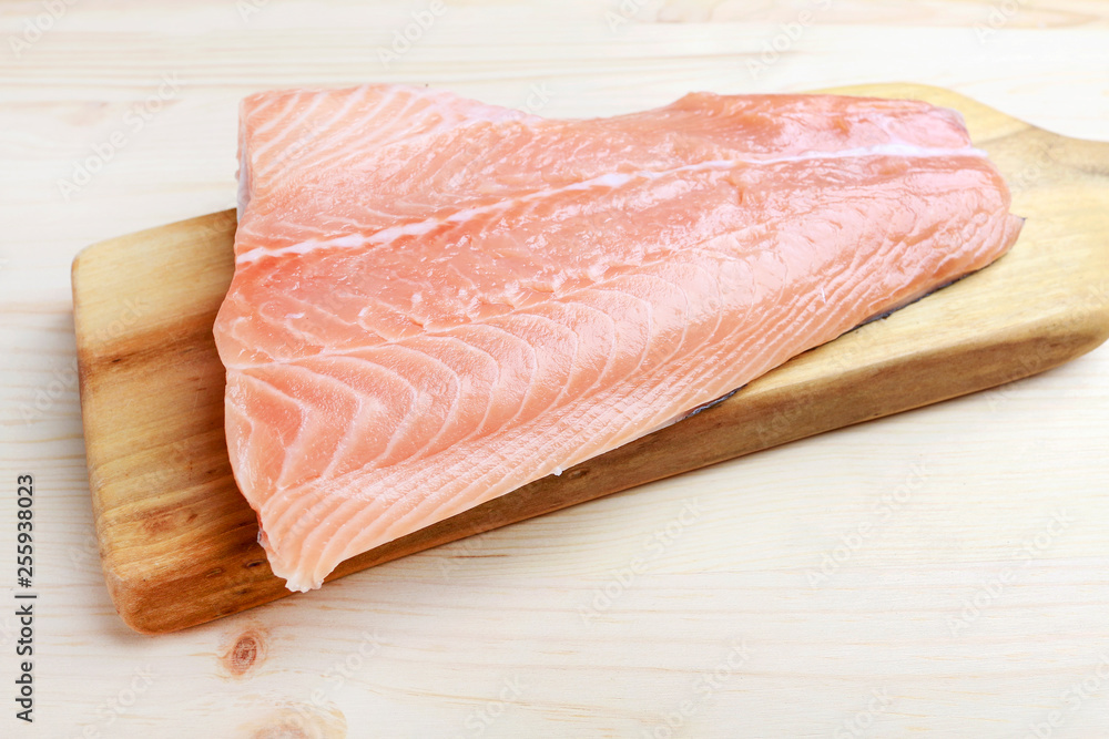 Raw salmon filet on wooden background Raw salmon filet on wooden background