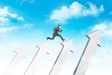 Attractive asian businessman jumping above white arrows
