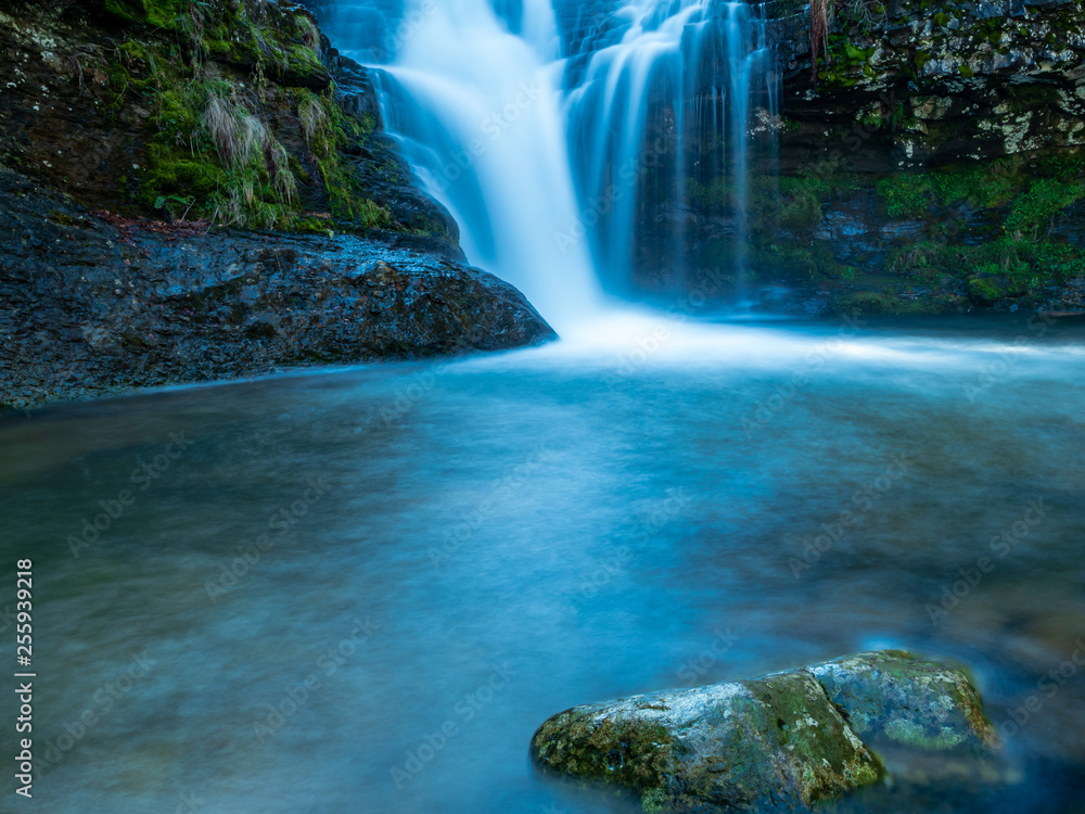 Blue waterfall among the mountains in the morning Blue waterfall among the mountains in the morning