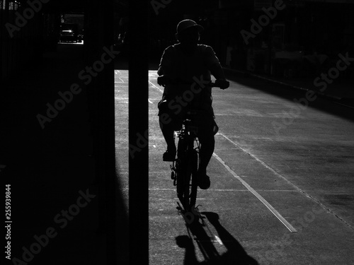 black and white silhouette people ride bicycle