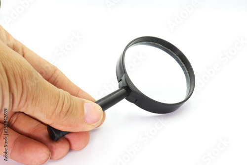 Hand holding Magniflying glass isolated on white background.