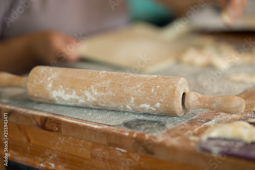 closeup of spin roll for dough laying on the table in the kitchen