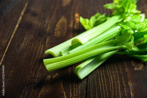 Celery stalks on wooden background