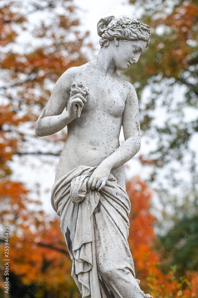 Statue of sensual naked Greek renaissance era woman with flowers, Potsdam, Germany, details, closeup