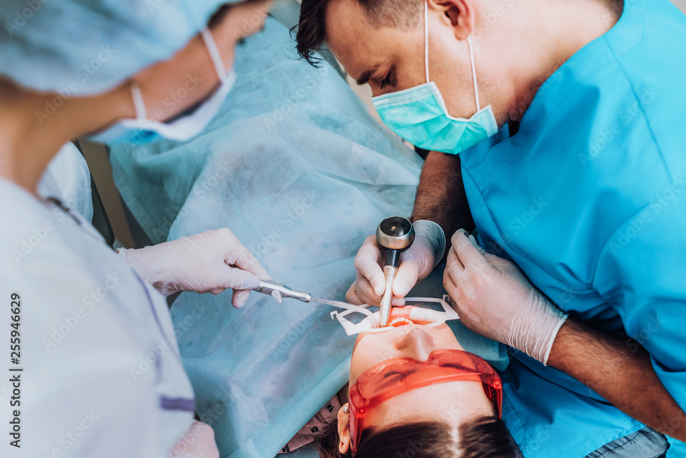 doctor orthodontist performs a procedure for cleaning teeth doctor orthodontist performs a procedure for cleaning teeth