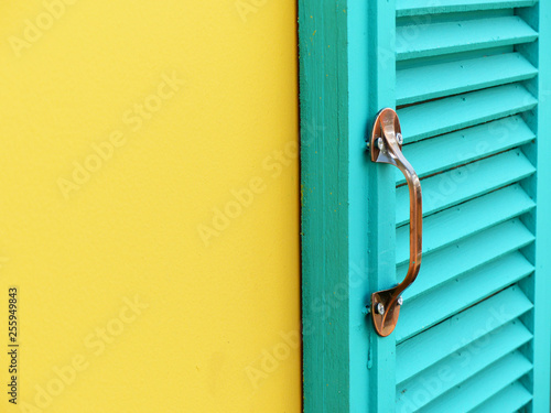 blue wood window on yellow wall