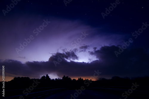 night sky with distant lightning storm and stars