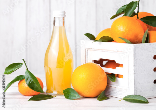 Glass bottle of fresh mandarin tangerine juice