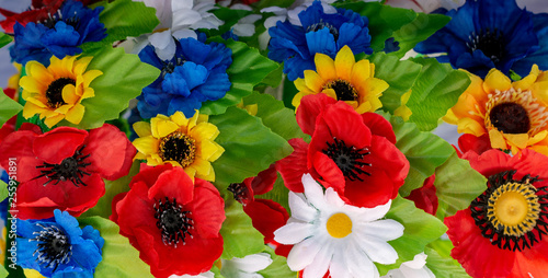 arrangement bouquet poppies  daisies  sunflowers  green leaves closeup