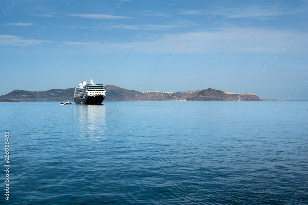 Cruise ship in the sea against rocky coastline