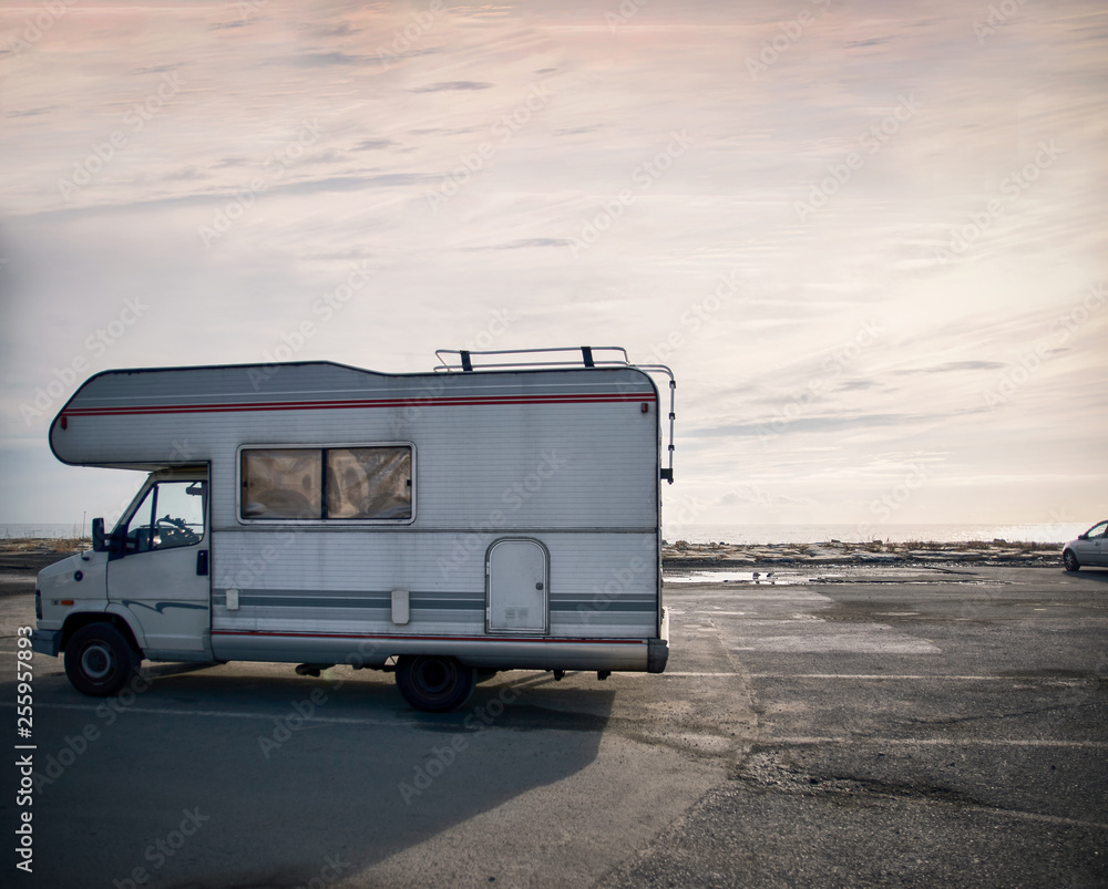 Road trip with a caravan mobile home. Camping caravanning in europe, beach  parking. Hippie van, old vintage camper van. Italian coast, mediterranean  tourism travel relaxing, leisure, family, driving. Photos | Adobe Stock