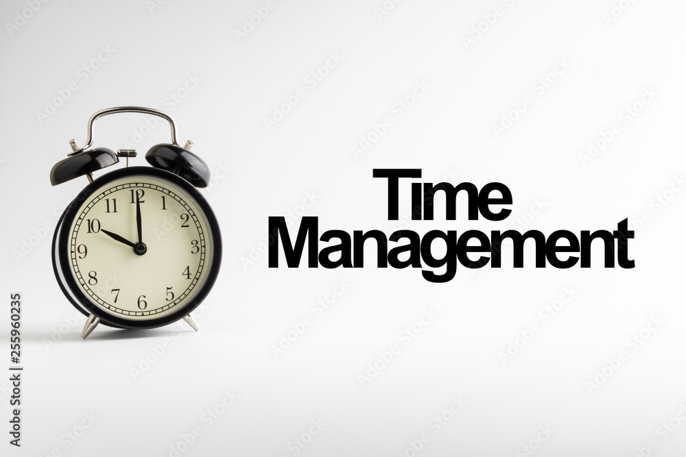 TIME MANAGEMENT inscription written and alarm clock on white background. Business and motivation concept TIME MANAGEMENT inscription written and alarm clock on white background. Business and motivation concept