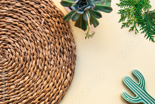 Flat lay with succulent, ceramic cactus and rustic straw. Trendy spring top view.
