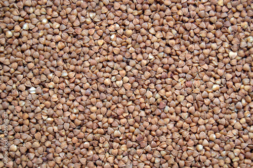 Buckwheat groats (lat. Fagopýrum esculéntum), top view, close-up. Healthy, natural food.