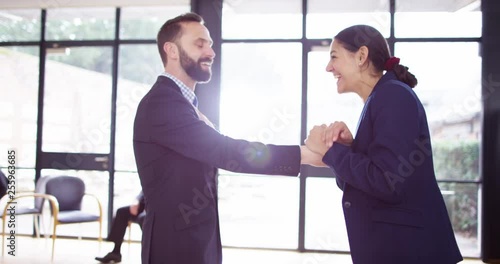 4K Socially awkward businessman attempts a high-five with colleague but misses photo