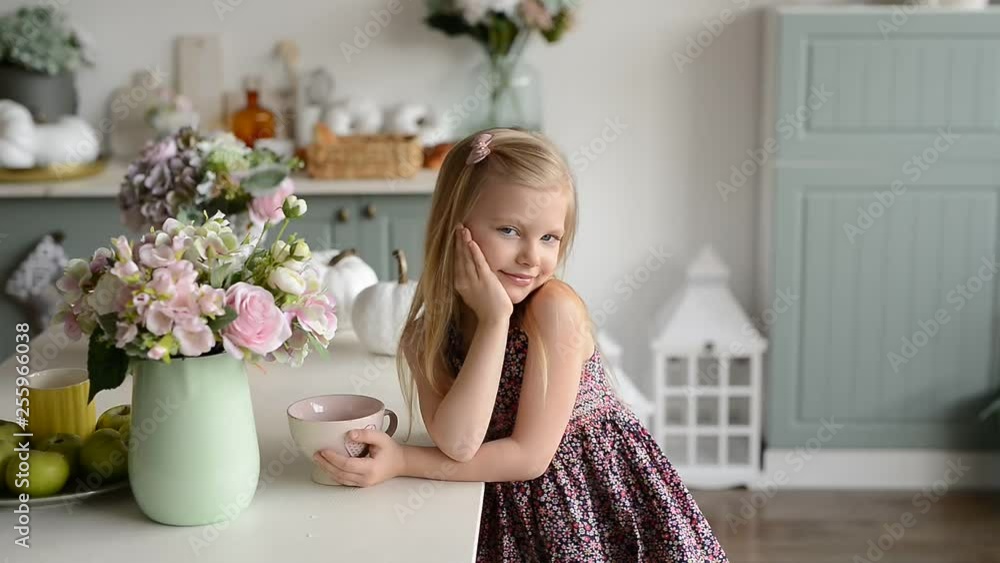 girl with a cup in the bright kitchen in the style of Provence girl with a cup in the bright kitchen in the style of Provence