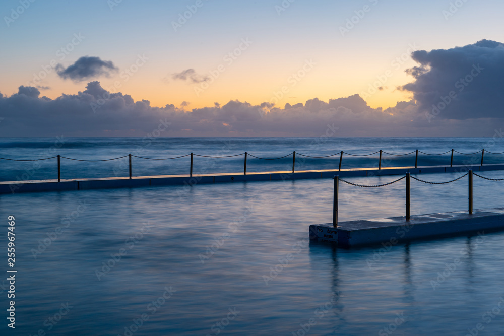 Sunrise view of empty rock pool at Curl Curl Beach, Sydney, Australia.