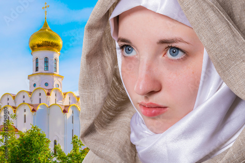 Fényképezés Beautiful pure girl with a clear look in a white scarf addresses prayer to God