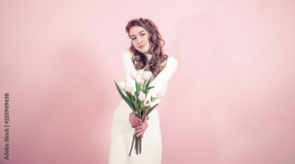 Young girl with tulips on a colored background Young girl with tulips on a colored background