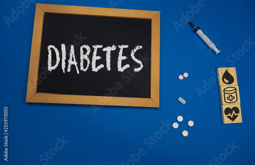 wooden tablet on blue medical table with the word DIABETES