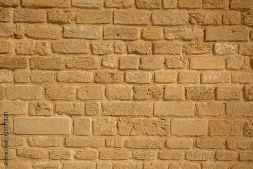 Brick yellow wall background. Old stone wall background.
