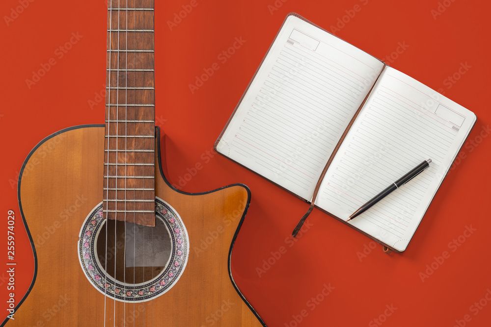 Fototapeta premium song writer table a workspace with musician acoustic guitar and notepad paper