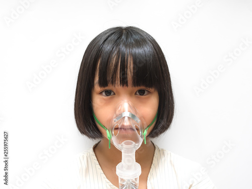 Asthma breathing in children problem concept. Asia pediatric patient kid girl with inhaler sick with bronchitis isolated on white background with copyspace.