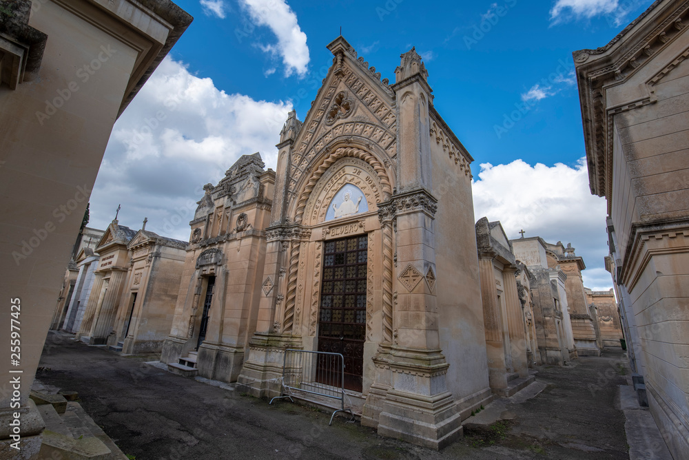 Old crypts and tombs in baroque style in Old Roman cemetery park (Cimitero Storico) in Lecce, Puglia, Italy. A region of Apulia