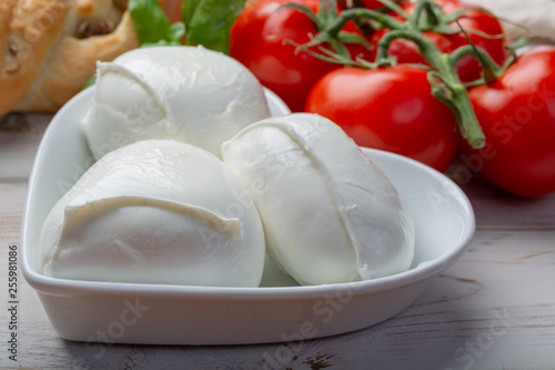 Love mozzerella, balls of buffalo mozzarella, soft Italian scheese made from the milk of Italian Mediterranean buffalo in heart shaped plate