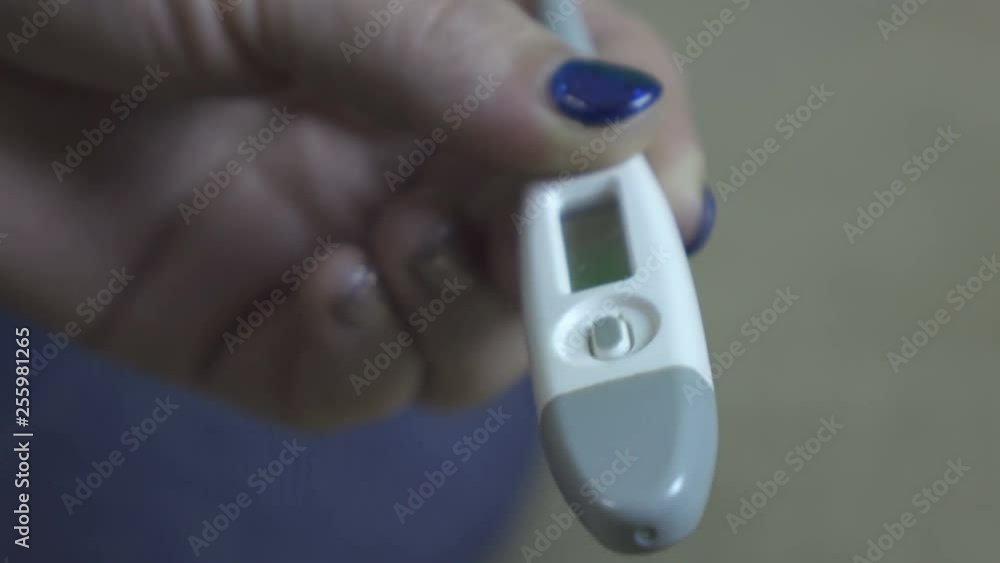 Woman holds a thermometer. Close-up. Cold, flu Woman holds a thermometer. Close-up. Cold, flu