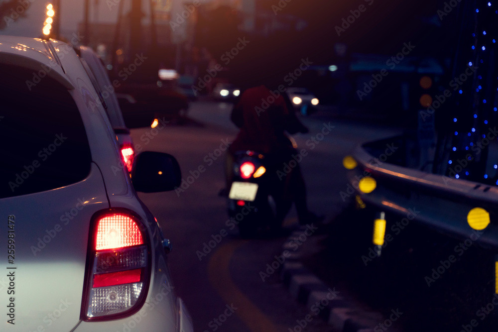 Fototapeta premium White car on stop on the crossroads at night with open light break.
