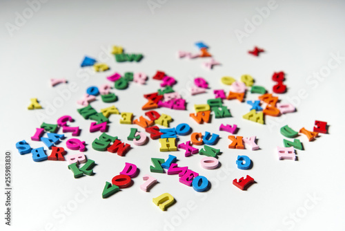 Colorful wooden alphabet letters scattered randomly
