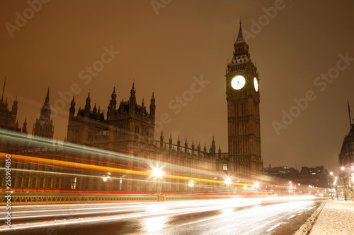 Snow covered Westminster Palace at dawn over dark grey sky © Sampajano-Anizza