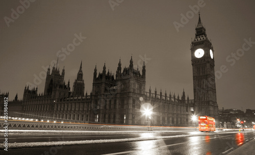Snow covered Westminster Palace at dawn over dark grey sky