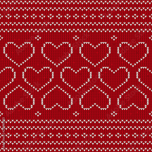 Red and white knitted background with hearts. Knitted pattern on a red background. Ornament. Valentine's Day background. Sweater texture hearts