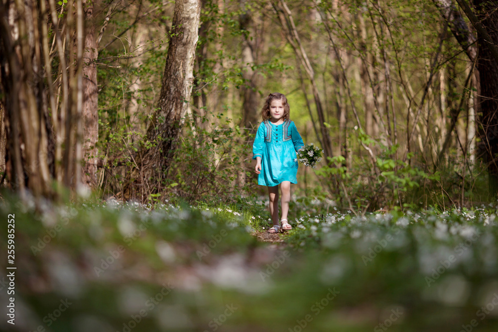 Little girl taking a walk all alone in a park or forest. Cute girl running on the road in the park on a sunny day. Family time. Little girl taking a walk all alone in a park or forest. Cute girl running on the road in the park on a sunny day. Family time.