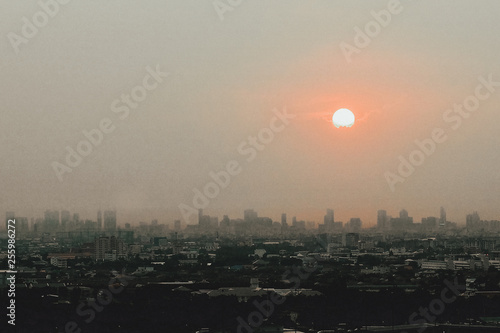 The fog and cloud covering the sun over the city.