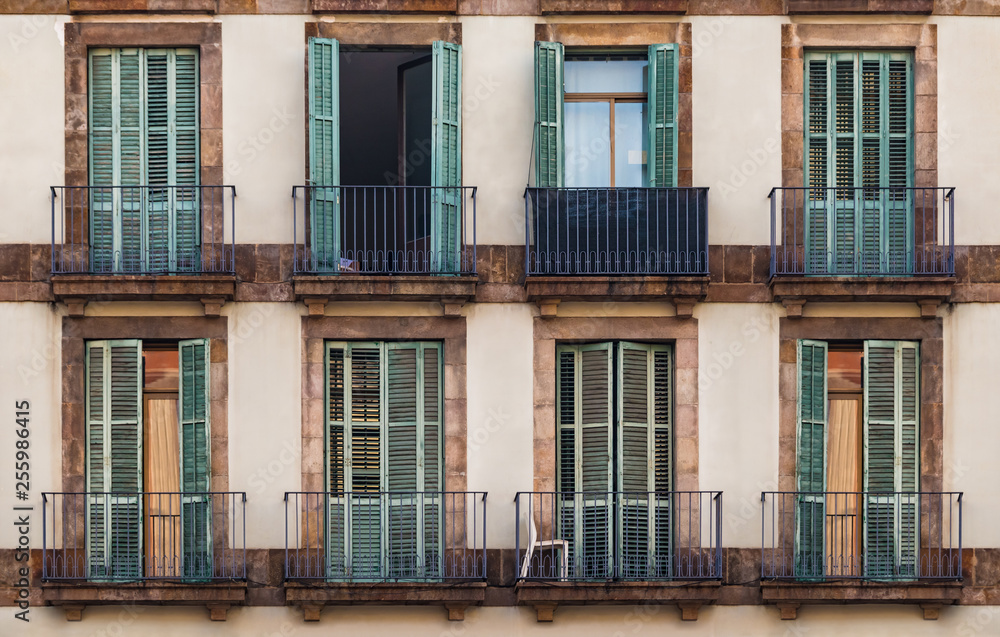 Windows and balconies in row on facade of historic building