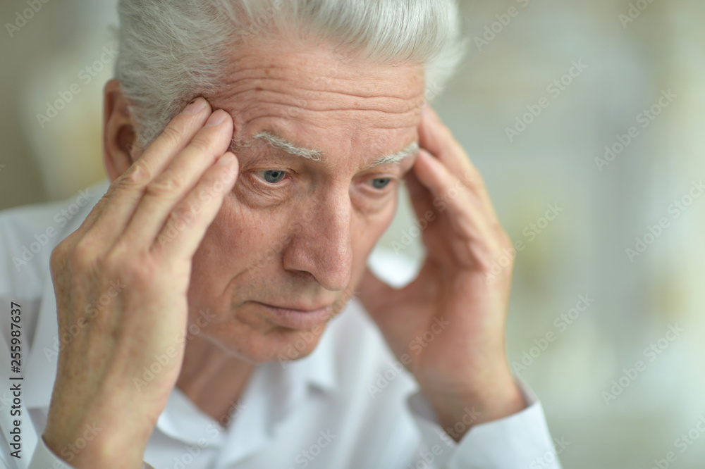 Close-up portrait of senior man with headache Close-up portrait of senior man with headache