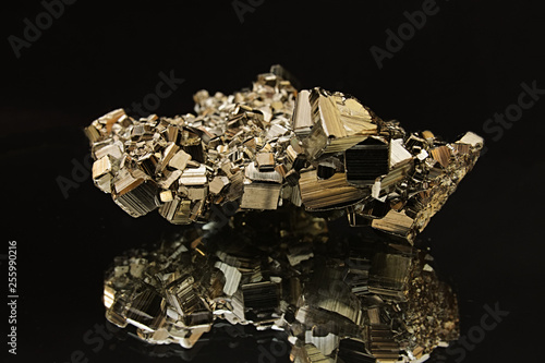 Mirror reflection of pyrite crystal on black background photo