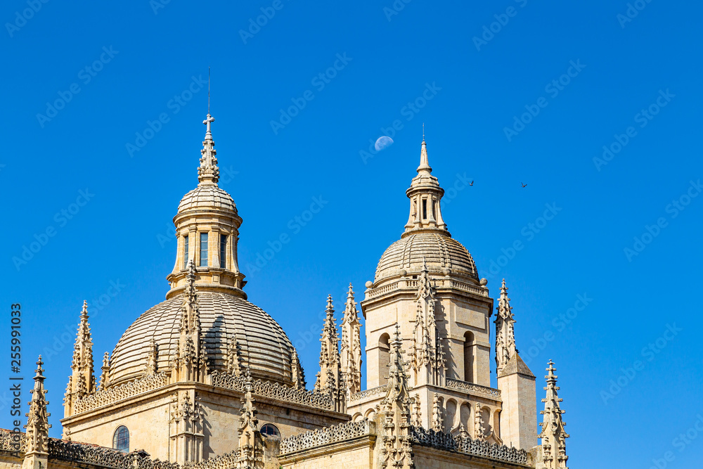 Segovia, Spain – The dome of the Cathedral of Segovia and the top of the bell tower with the moon behind in Summer