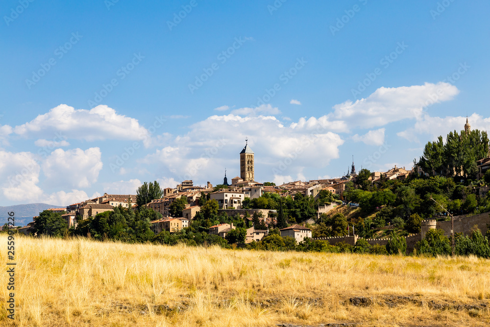 View of Segovia Old Town in Summer from the field next to Iglesia de la Vera Cruz, an ancient Templar church. Castilla Y Leon, Spain View of Segovia Old Town in Summer from the field next to Iglesia de la Vera Cruz, an ancient Templar church. Castilla Y Leon, Spain