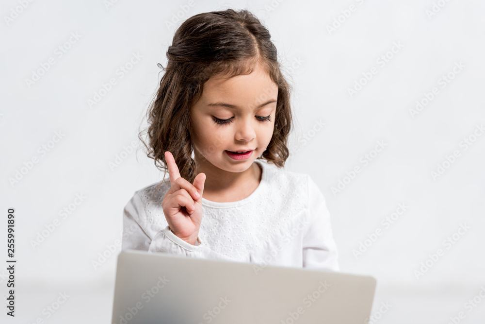 Funny brunette preschooler kid waving hand isolated on white Funny brunette preschooler kid waving hand isolated on white