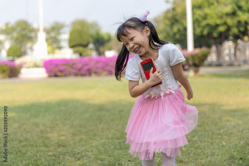 a girl pink dress happily playing running in the garden a girl pink dress happily playing running in the garden