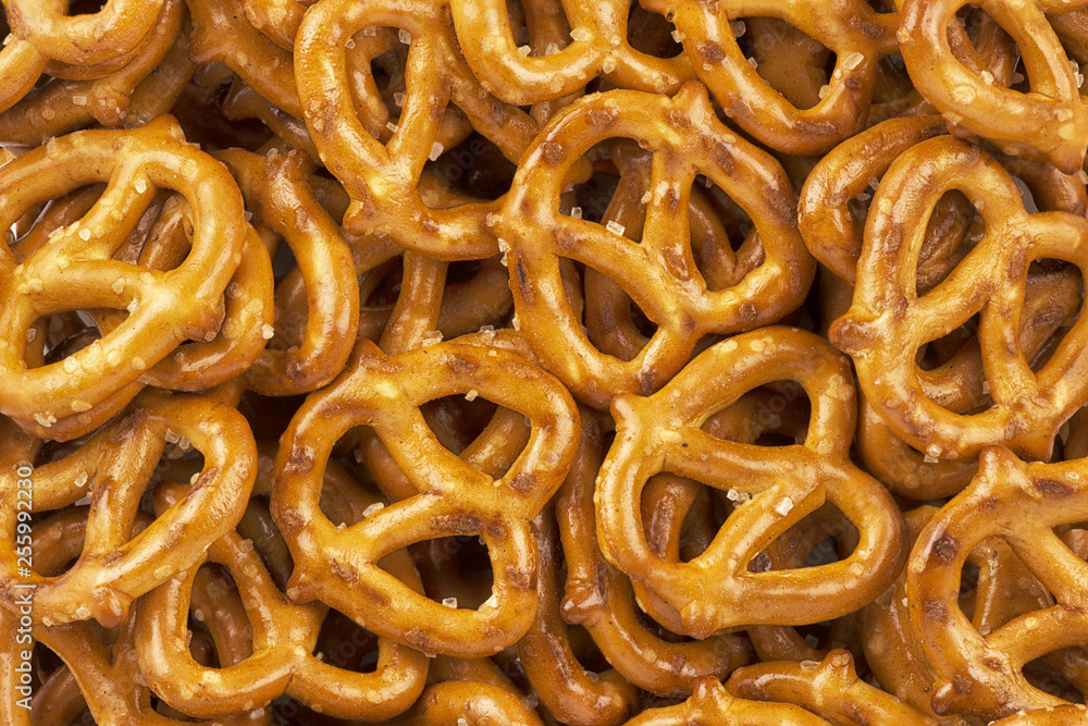 Lot of whole mini salted pretzels stack flatlay as abstract background. Copy space for your text. Lot of whole mini salted pretzels stack flatlay as abstract background. Copy space for your text.