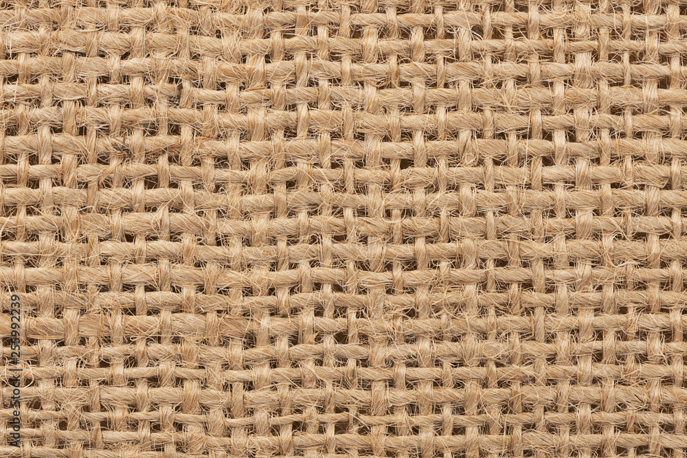 Close up on a burlap texture as abstract background. Copy space for your text. Close up on a burlap texture as abstract background. Copy space for your text.