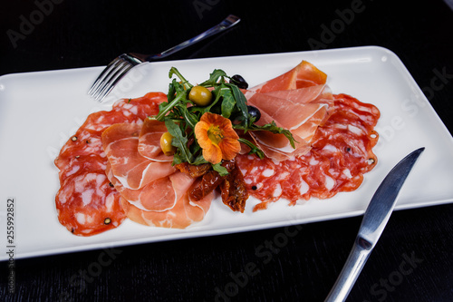 Meat slicing platter - prosciutto ham, bresaola, pancetta, salami and parmesan photo