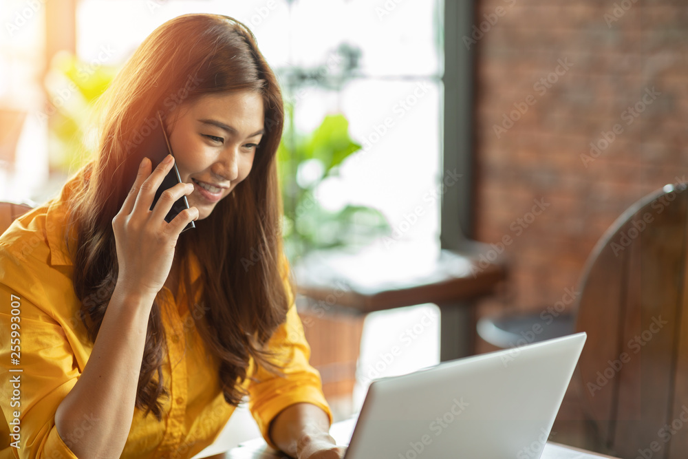 Beautiful Attractive Asian woman working with laptop smile and talking with customer in smartphone to get idea and requirement for success job outside office in coffee shop,Business Startup Concept Beautiful Attractive Asian woman working with laptop smile and talking with customer in smartphone to get idea and requirement for success job outside office in coffee shop,Business Startup Concept